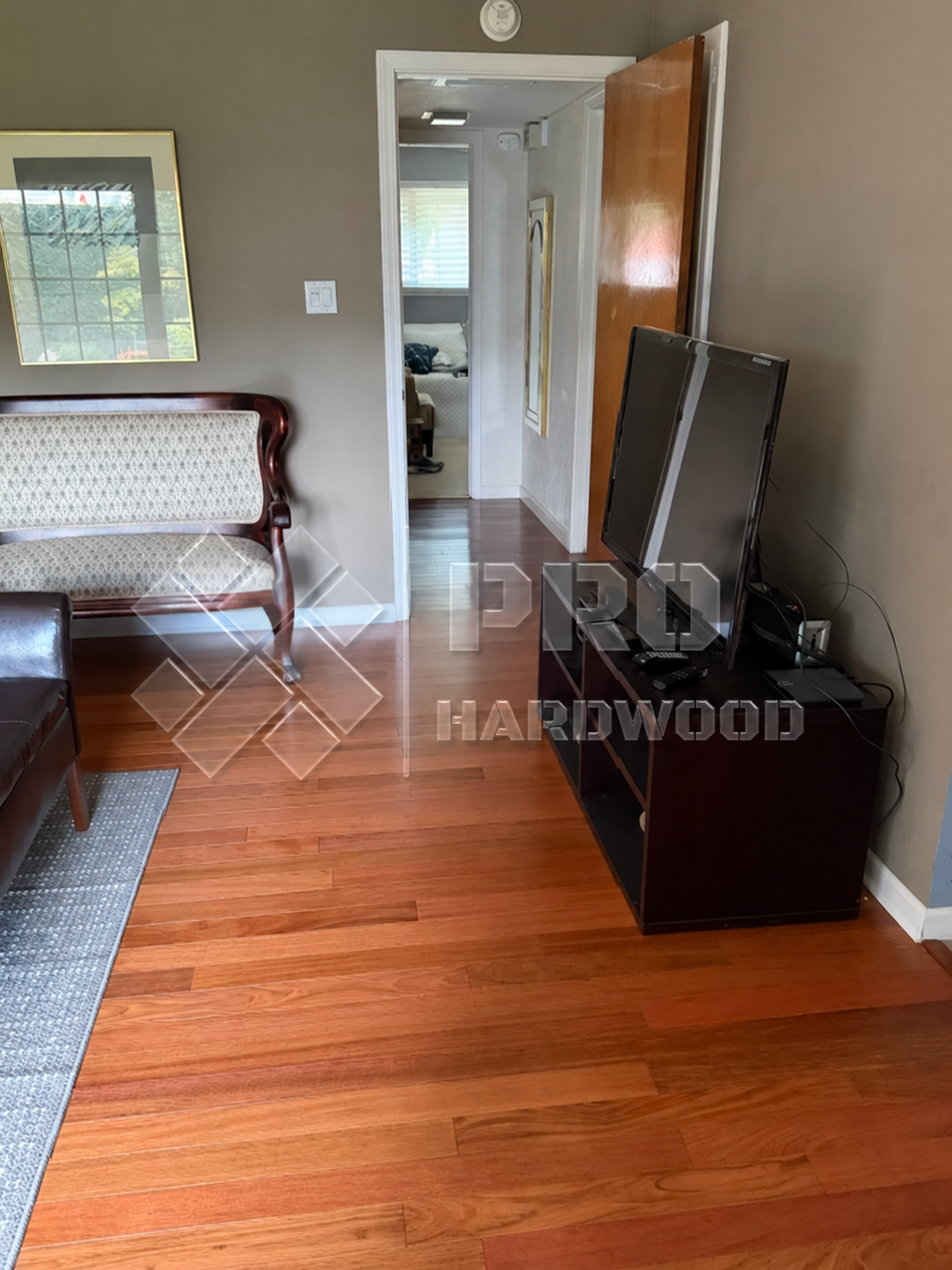 Brazilian Cherry hardwood flooring installed in a bedroom, view 4