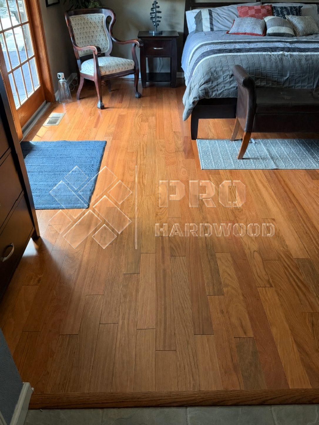 Brazilian Cherry hardwood flooring installed in a bedroom, view 2