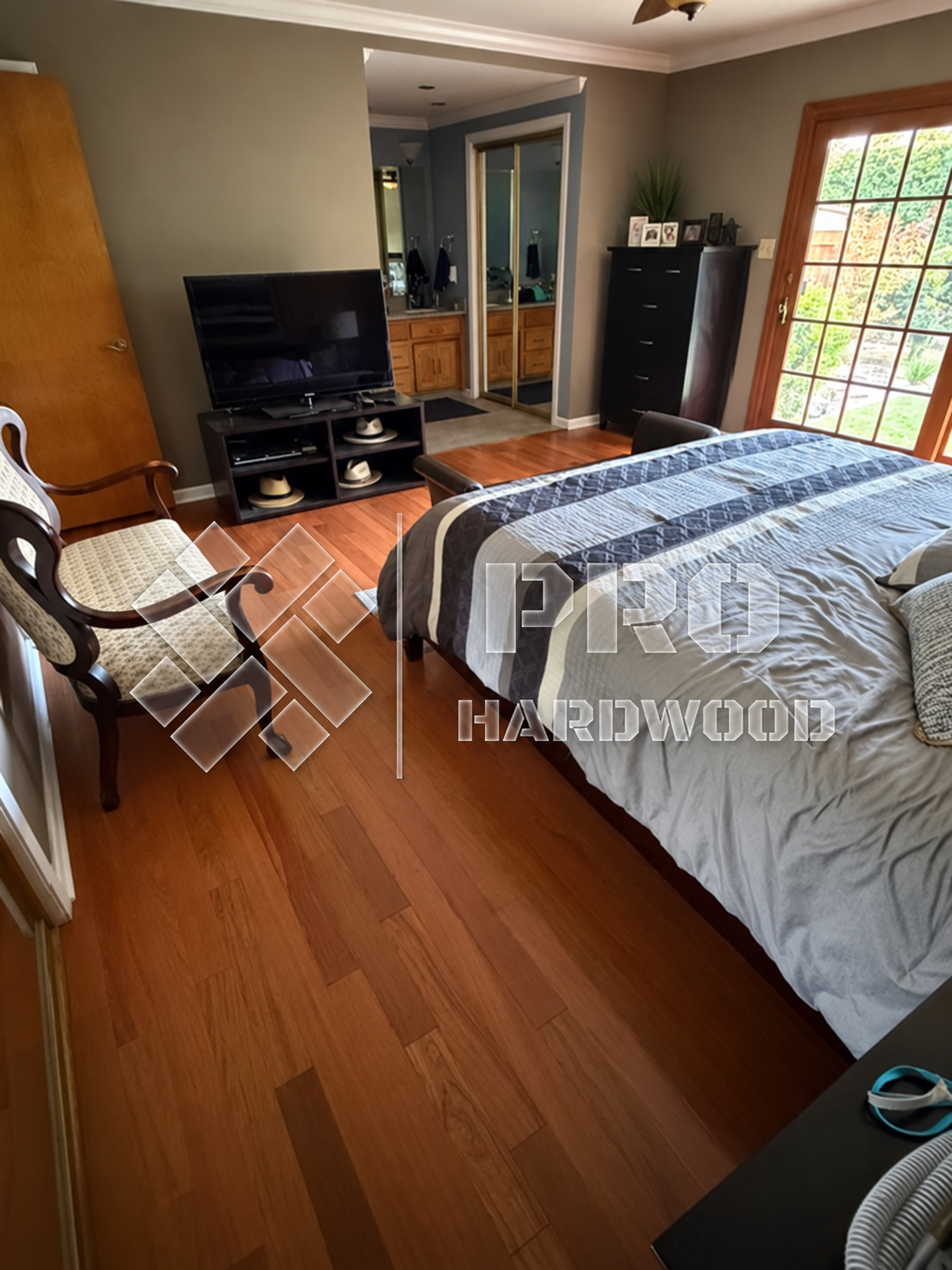 Brazilian Cherry hardwood flooring installed in a bedroom, view 1